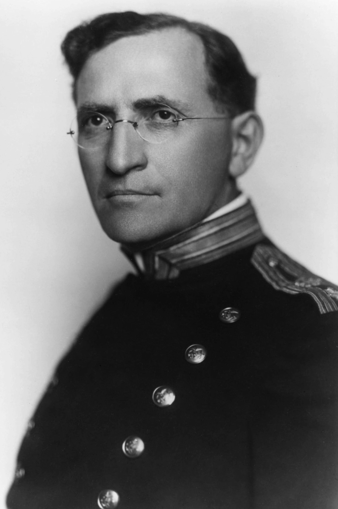 A studio portrait of Joseph Goldberger in the dark uniform of the Public Health Service, with rimless spectacles and a high collar