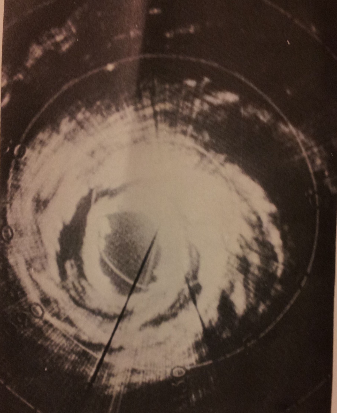 A circular radar display of a hurricane with a dark eye at the centre, a bright ring of echoes around it and a second, broken ring of echoes farther out