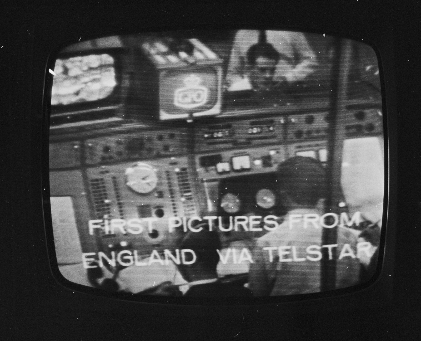 A television monitor showing a control room with the caption First Pictures From England Via Telstar